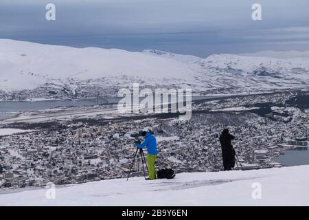 Photographers capturing the view from above Tromso, Norway Stock Photo