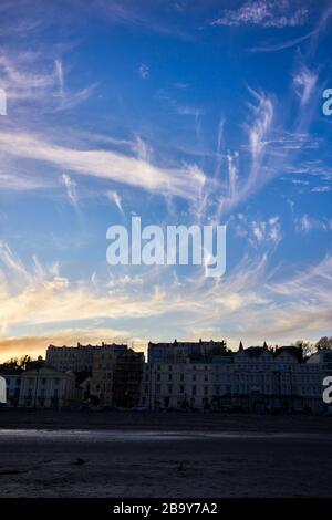 The hotels and apartments on Douglas Bay, Isle of Man at dusk with whispy clouds in the sky Stock Photo