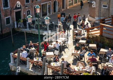 People and tourists in a restaurant on Grand Canal in the Italian city of Venice Stock Photo