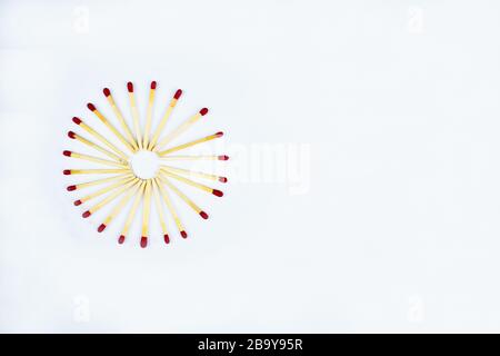 Photo of a circle made with flammable red fire matches on a white paper background Stock Photo