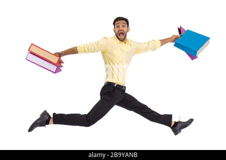 A man in a hand holding a paper bag, shopping, jumping, isolated on the white background. Stock Photo