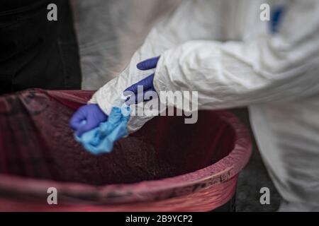 Holmdel, United States. 25th Mar, 2020. A medical technician changes out gloves between patients at a COVID-19 Community-Based Testing Site at the PNC Bank Arts Center in Holmdel, N.J., on March 23, 2020. The testing site, established in partnership with the Federal Emergency Management Agency, is staffed by the New Jersey Department of Health, the New Jersey State Police, and the New Jersey National Guard. This image was captured with a tilt-shift lens. Photo by Master Sgt. Matt Hecht/U.S. Air National Guard/UPI Credit: UPI/Ģ����ý Live News Stock Photo