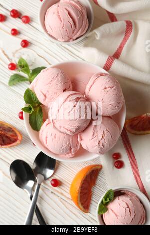 Bowls with ice cream balls on white wooden table, top view Stock Photo