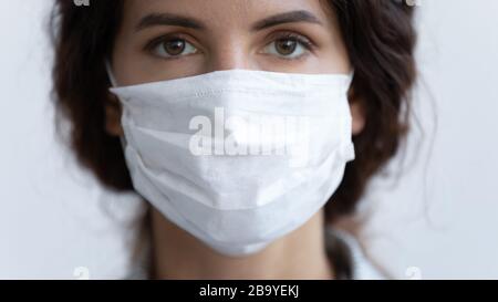 Portrait of young woman wearing medical protective mask Stock Photo
