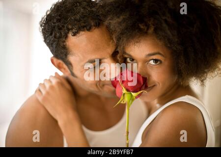 Affectionate couple smelling the rose together. Stock Photo