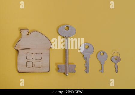 A house with keys of different sizes, the concept of a mortgage, different interest payments on a mortgage, moving or renting real estate. For realtor Stock Photo