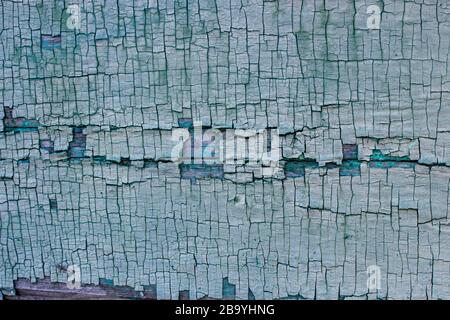 Abstraction of the body of old green cracked paint on a wooden surface. Stock Photo