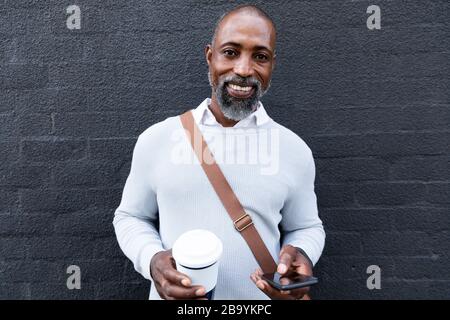 African American man using his phone in the street Stock Photo