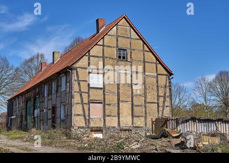 Old half-timbered house facade with exposed wooden beams. The old building is being restored Stock Photo
