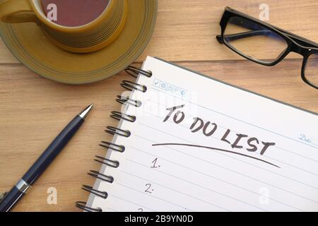 tea cup and notebook with to do list on wooden table  Stock Photo