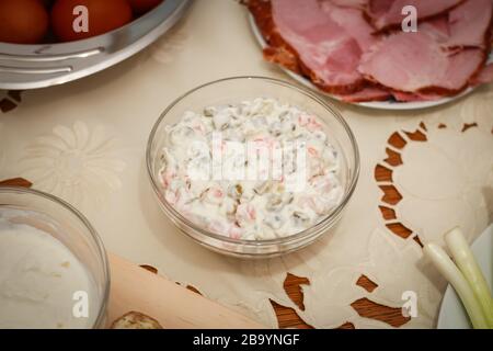Traditional Easter breakfast, french salad in a glass jar on the table. Stock Photo