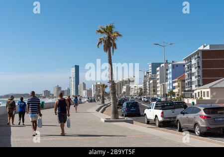 Strand, Somerset West, Western Cape, South Africa. Dec 2019. Holidaymakers walk along the seafront  at Strand a popular seaside resort close to Somers Stock Photo