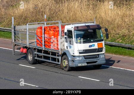 Calor Gas Haulage delivery trucks, lorry, transportation, truck, cargo carrier, DAF vehicle, European commercial transport, industry, M6 at Manchester, UK Stock Photo