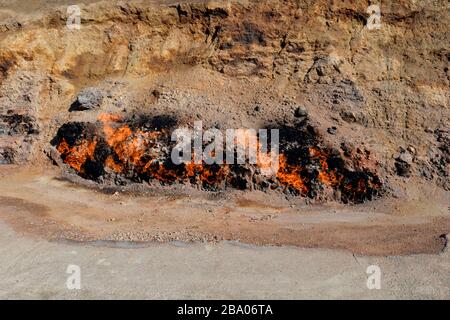 Fire burning from the ground at Yanar Dag due to natural gas blazing on a hillside on the Absheron Peninsula in Azerbaijan. Burning Mountain. Stock Photo