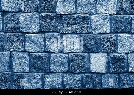Granite stones wall background Color of the year 2020 classic blue toned Stock Photo