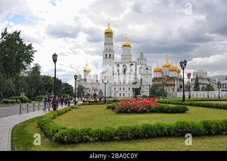 = Flowerbed and Architectural Ensemble of Moscow Kremlin in Summer =  View from Spasskaya (Savior) Tower of Moscow Kremlin on a flowerbed and amazing Stock Photo