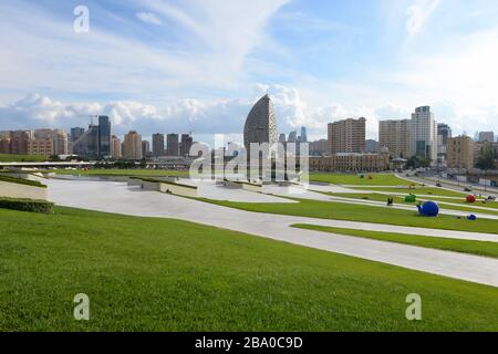 Baku Central Park overlooking the city skyline. Located in front of Heydar Aliyev Cultural Center Complex in Azerbaijan. Garden with pathways. Stock Photo