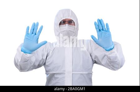 man epidemiologist in coverall disposable anti-epidemic antibacterial isolation suit shows a prohibitory gesture with two hands, isolated on white bac Stock Photo