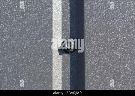 Fastening of metal corrugated fence, abstraction of metal surface with hard shadow. Stock Photo