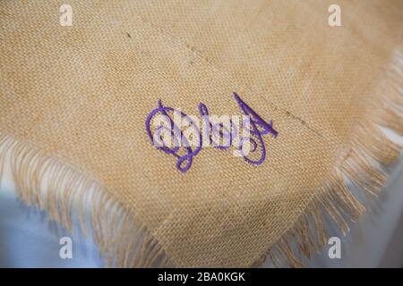 table runner with purple writing at a wedding day Stock Photo