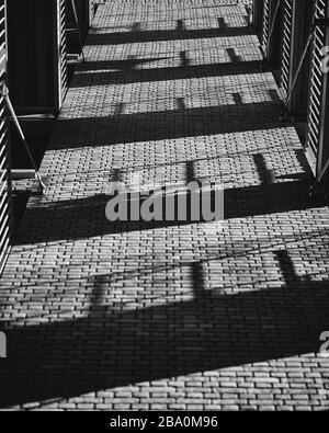Balconies shadows cast on a brick wall Stock Photo