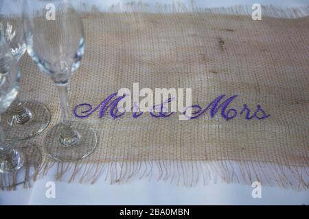 table runner with purple writing at a wedding day Stock Photo
