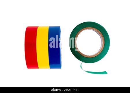 Several round rolls of multi-colored plastic electrical tape to protect against electric current lies in a row. Isolated on white background. Flat lay Stock Photo