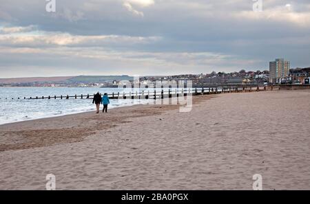 Portobello, Edinburgh, Scotland, UK. 25th March 2020. Extremely quiet afternoon  in Portobello on Beach a few  cildren playing and pedestians walking the dog. Temperature of 13 degrees centigrade. Stock Photo