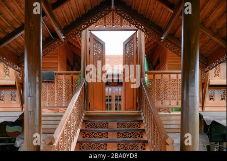Classic asian wooden house with carving door opening with stairs Stock Photo