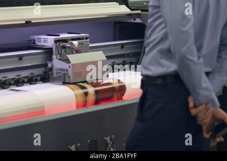 Large-format printing machine in the printing house. Industry Stock Photo