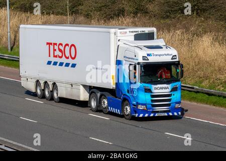 WS Transportation Tesco supermarket food Haulage delivery trucks, lorry, transportation, truck, foodstuffs cargo carrier, Scania vehicle, European commercial transport, industry, M6 at Manchester, UK Stock Photo