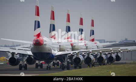 Glasgow, UK. 25th Mar, 2020. Pictured: British Airways Airbus Aircraft stand grounded on the tarmac at Glasgow Airport. The group of Airbus Aircraft comprise of Airbus A321, A320 and one A319 aircraft. Credit: Colin Fisher/Alamy Live News Stock Photo
