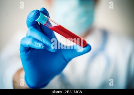 Scientist hold Blood Test. New Epidemic Coronavirus 2019 nCoV. Background with copy space. Horizontal. Stock Photo