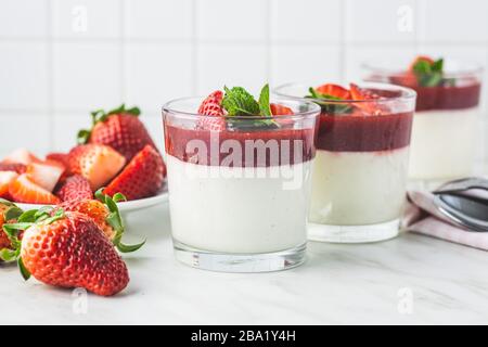 Italian dessert panna cotta in glass with strawberries. Stock Photo
