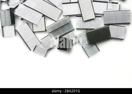 Paper clips from a stapler on an isolated white background Stock Photo