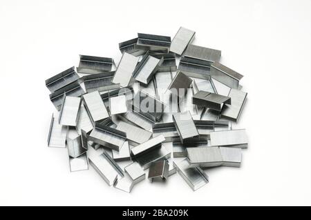 Paper clips from a stapler on an isolated white background Stock Photo