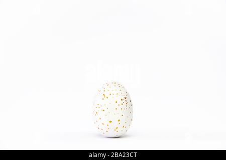 Minimal easter card. One easter trendy golden decorated egg on white background. Copy space for text Stock Photo