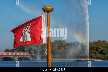 Hamburg coat of arms in front of the Alster fountain in Hamburg with rainbow Stock Photo