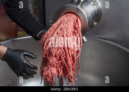 Meat-grinder, grinding fresh meat into minced meat Stock Photo - Alamy