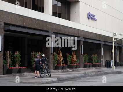 SAN ANTONIO, TX--Police officers stand in front of the closed Jyatt Regency Hotel  25th Mar 2020. San Antonio has enacted a stay-at-home rule with restaurants, hotels and tourist destinations closing to combat the spread of the Coronavirus Covid-19. Stock Photo