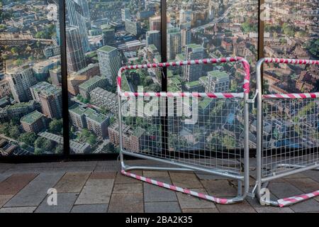 As the number of UK Coronavirus cases rose to over 8,000, it was announced that thousands of 15-minute home tests could be made available within days to those self-isolating with symptoms. A barrier surrounds an image of the Elephant & Castle development (aka Elephant Park), on 25th March 2020, in London, England. Stock Photo