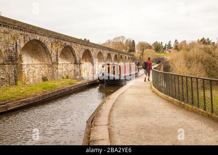 Narrow boat passing over the Thomas Telfod  built aqueduct at Chirk North Wales with Chirk Railway Viaduct running alongside over the Ceiriog Valley Stock Photo