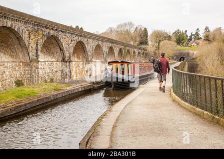 Narrow boat passing over the Thomas Telfod  built aqueduct at Chirk North Wales with Chirk Railway Viaduct running alongside over the Ceiriog Valley Stock Photo