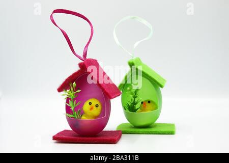 Easter chicks in houses made of colorful eggs Stock Photo