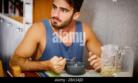 Attractive Young Man Eating Breakfast Stock Photo