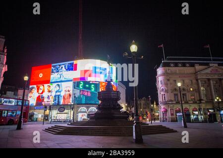 Piccadilly Circus, London, UK. 25th Mar, 2020. In an attempt to slow the spread of Coronavirus, Prime Minister Boris Johnson orders the UK to 'stay home' leaving usually busy roads and streets in London empty. Credit: Marcin Nowak/Alamy Live News Stock Photo