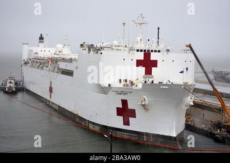 The U.S. Navy Military Sealift Command hospital ship USNS Comfort  takes on fuel and supplies March 25 at Naval Station Norfolk before being deployment to assist in the COVID-19, coronavirus response March 25, 2020 in Norfolk, Virginia. Stock Photo