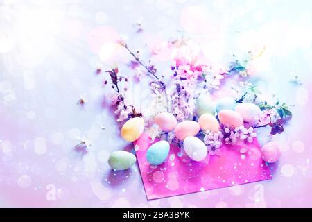 Easter eggs with cherry blossom and a pink envelope Stock Photo