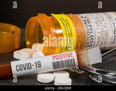 Morgantown, WV - 25 March 2020: Bottle of Oxycodone opoid pain killing tablets with positive coronavirus test Stock Photo