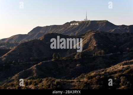 LOS ANGELES, CA/USA - FEBRUARY 6, 2020: A dramatic view of the Hollywood Sign over the mountains from the Griffith Observatory Stock Photo